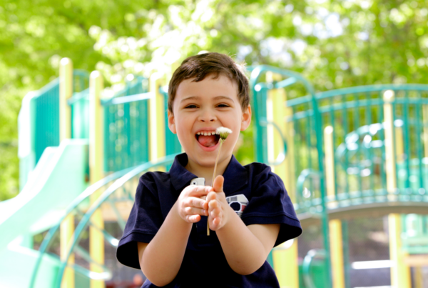 child with a dandelion at the park