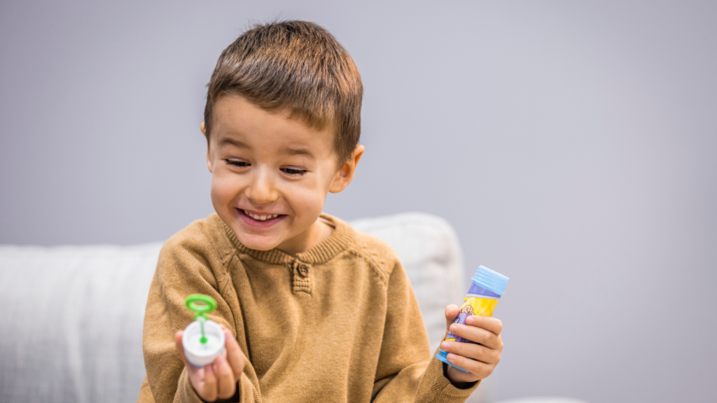 child playing with bubbles