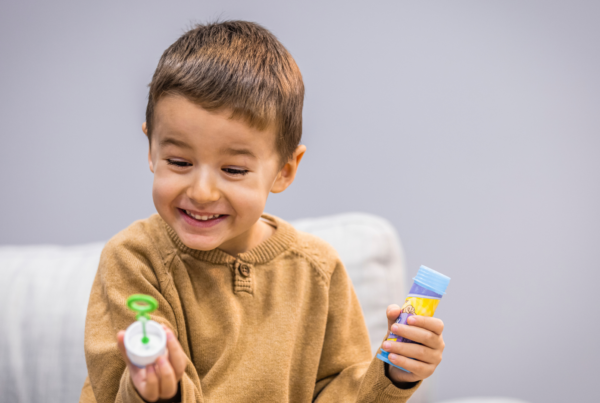 child playing with bubbles