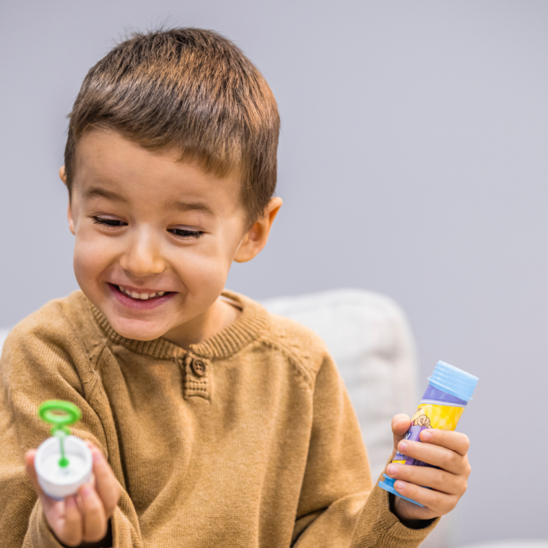 child playing with bubbles