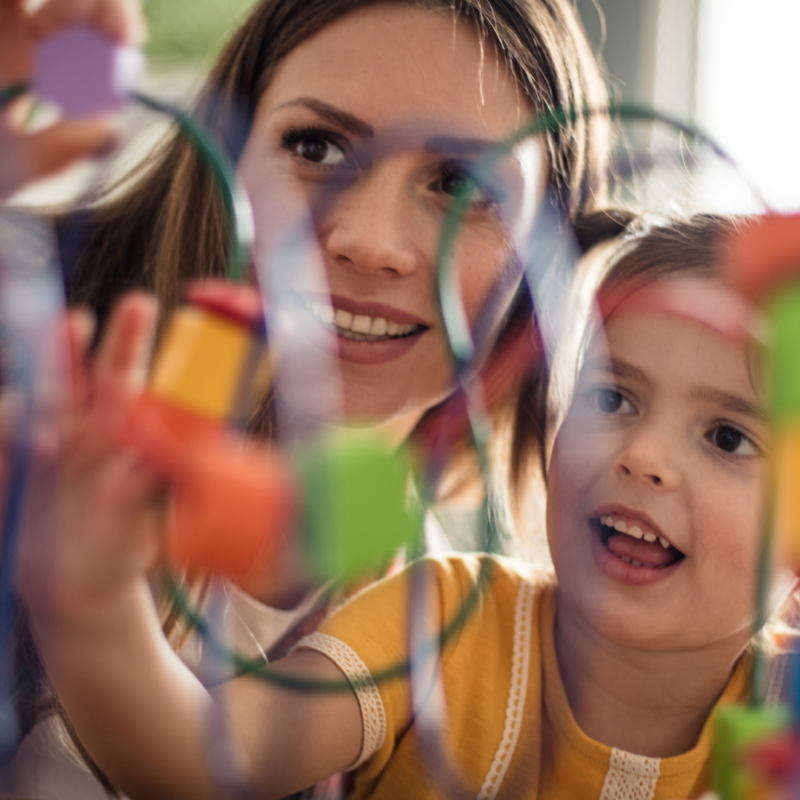 Child playing with block toy with parent Early Intervention for Autism
